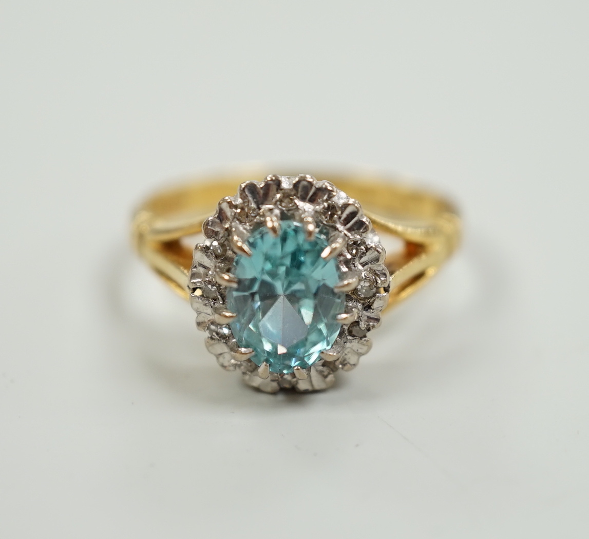 An 18ct, blue zircon and illusion set diamond oval cluster ring, size M, gross weight 5 grams.